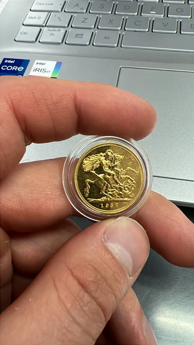 Close view of a historic gold sovereign in a protective capsule