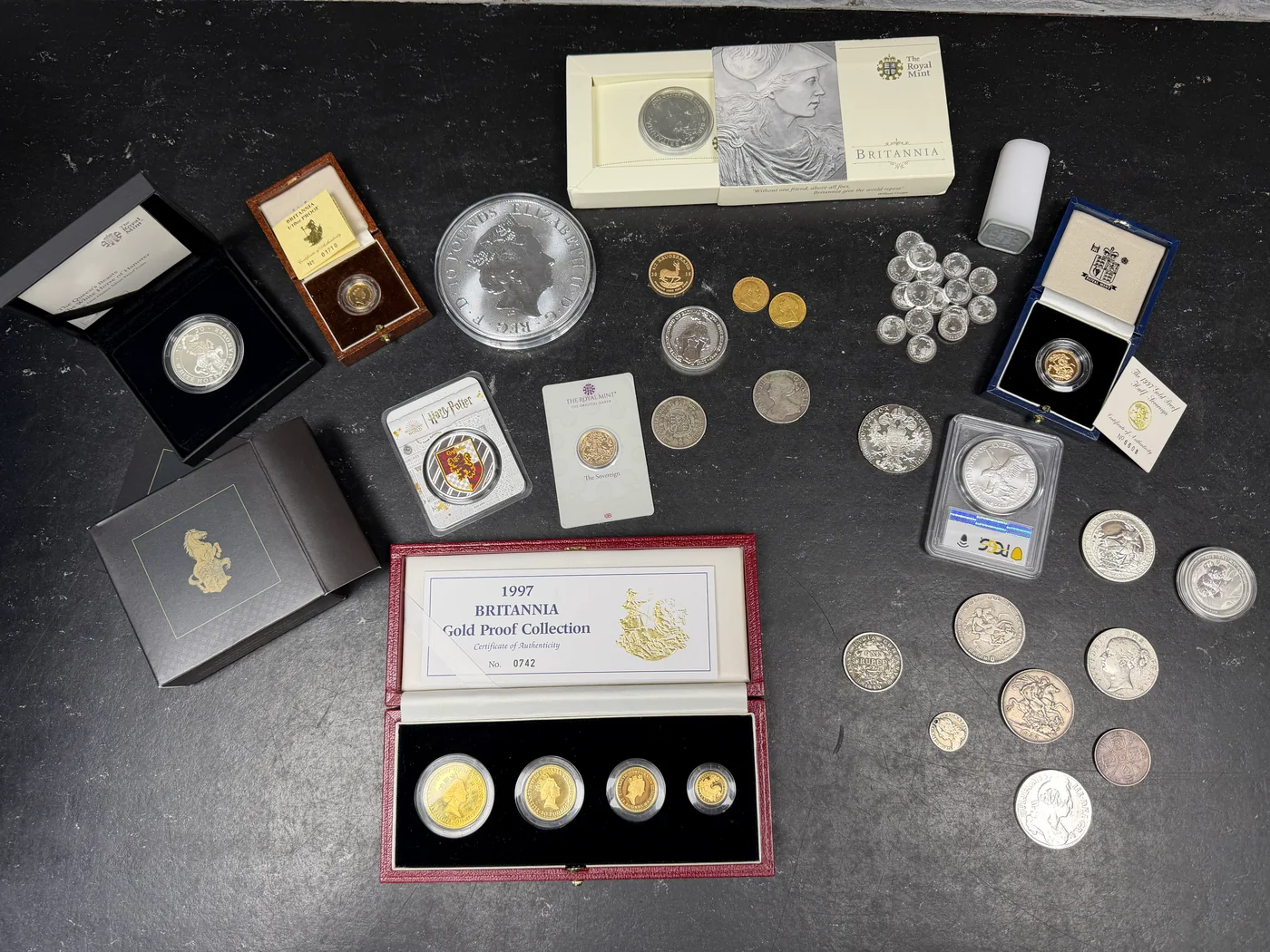A mixed collection of gold and silver coins with presentation cases and certificates