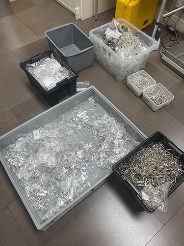 Boxes of scrap silver on the Lois Bullion office floor awaiting sorting, melting, and valuing.