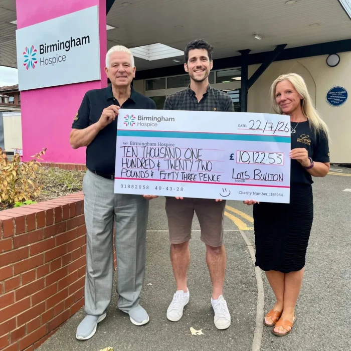 Steve Doughty, Luke Manley and Amy Jackson holding a £10,122.53 donation cheque outside Birmingham Hospice