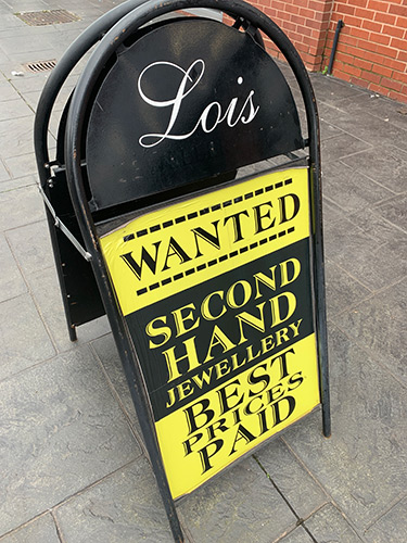 Lois Bullion shop sign reading 'Wanted second hand jewellery best prices paid.'